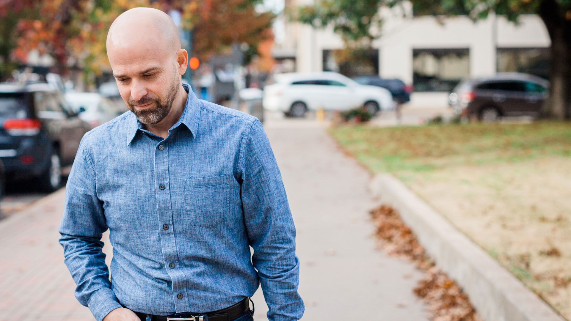 Chris Meyer walking on a tree-lined city sidewalk